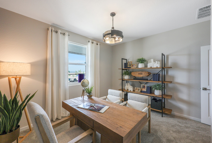 A dining room with a table and chairs.
