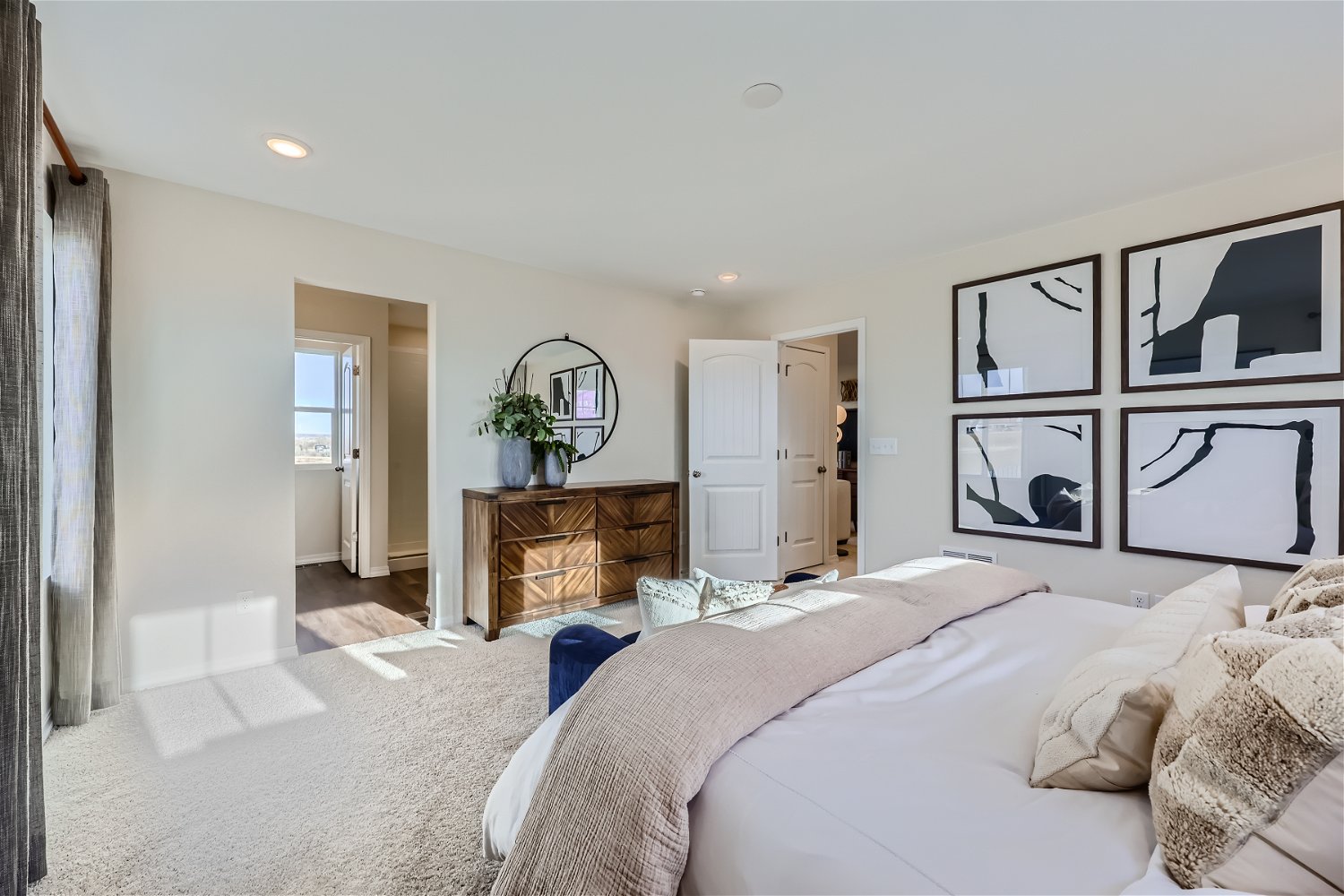 A bedroom with a bed and a mirror.