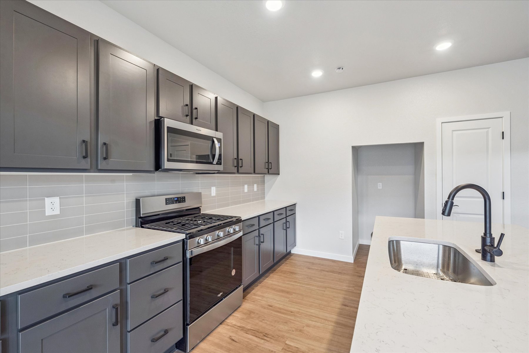 A kitchen with black cabinets.