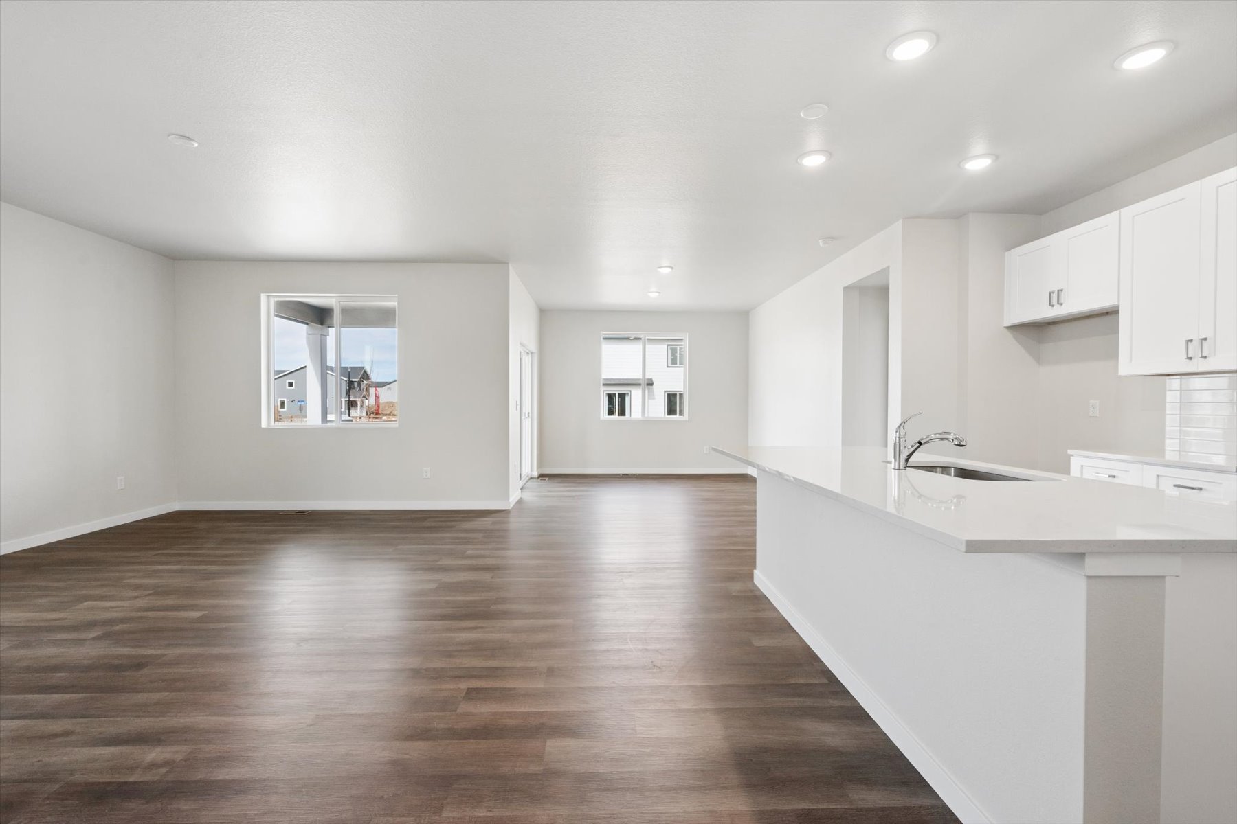 A kitchen with white cabinets.