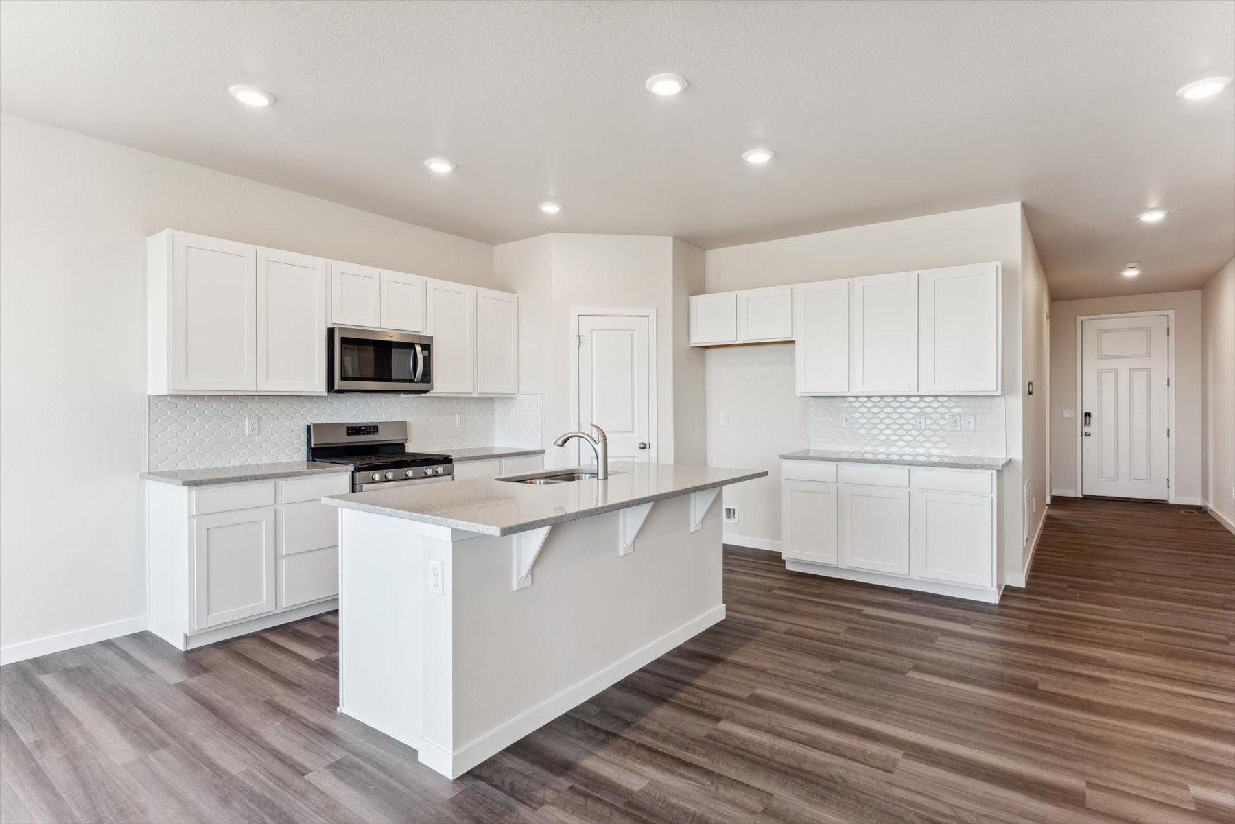 A kitchen with white cabinets.