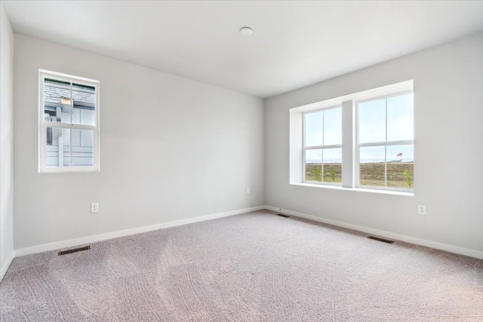 A room with a window and a carpet.