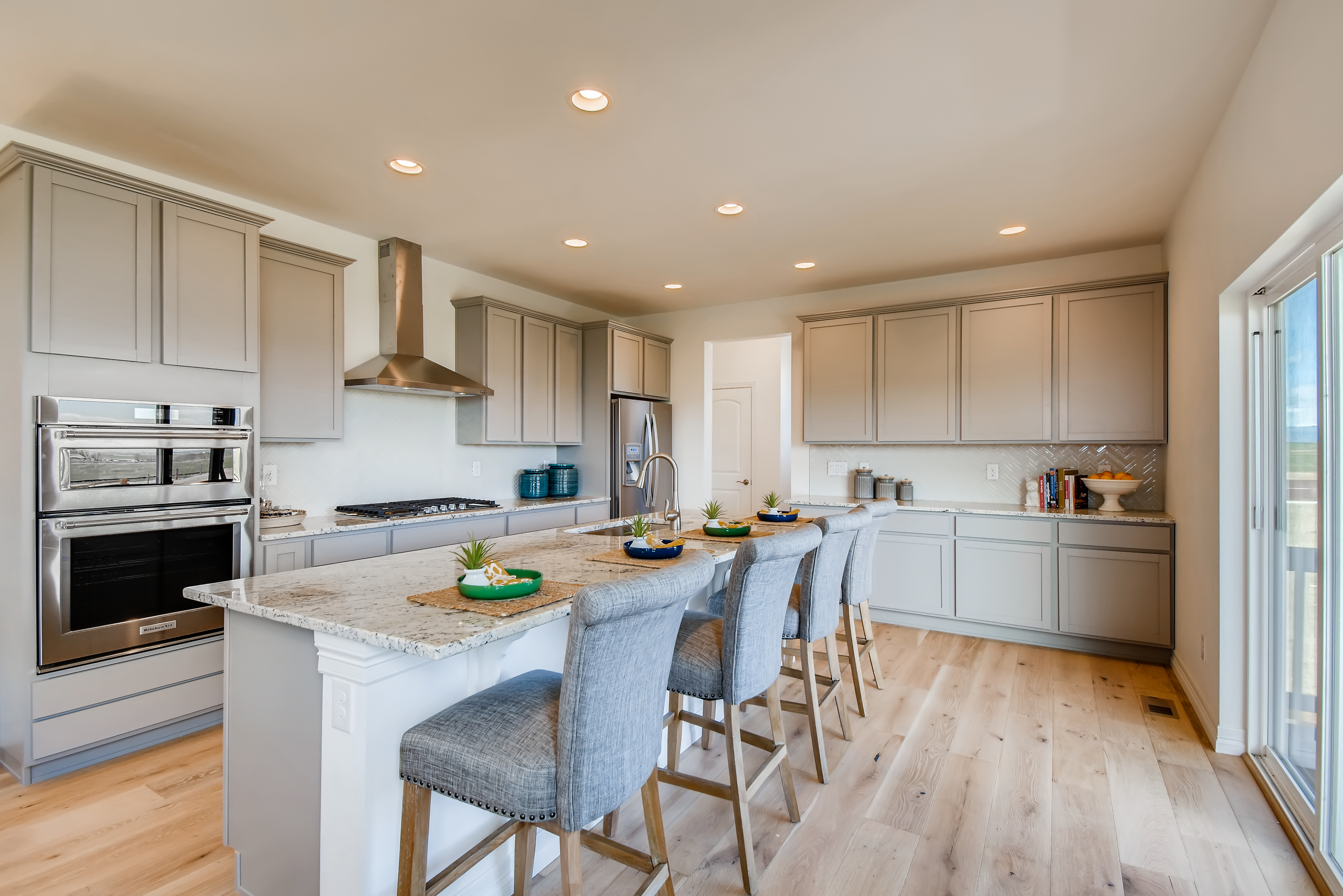 A kitchen with white cabinets.
