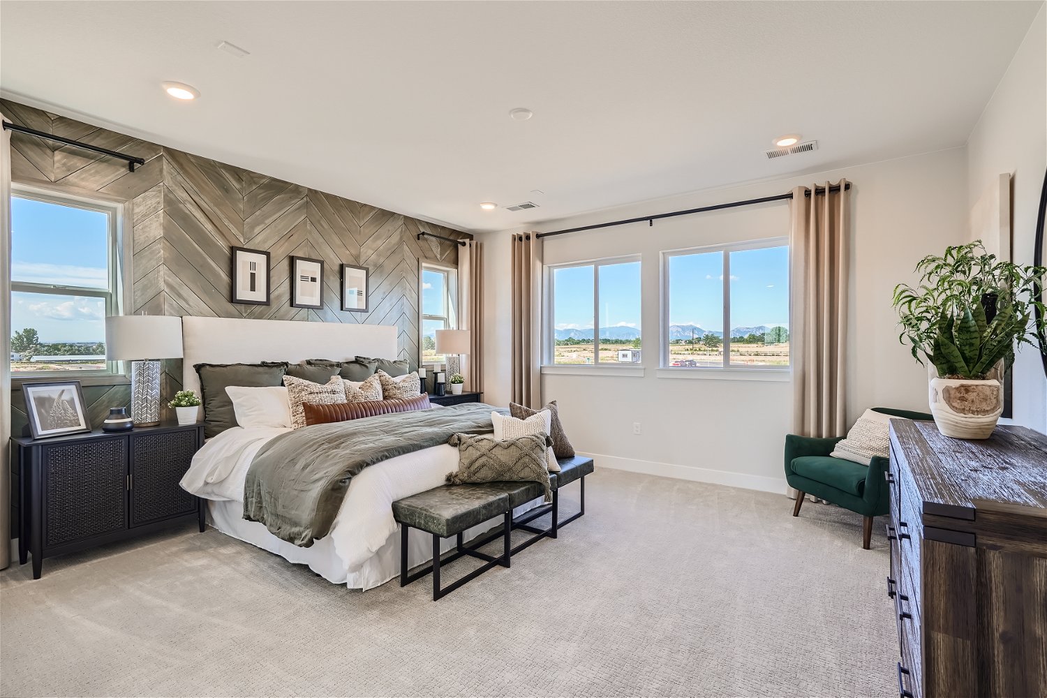 A bedroom with a large window.