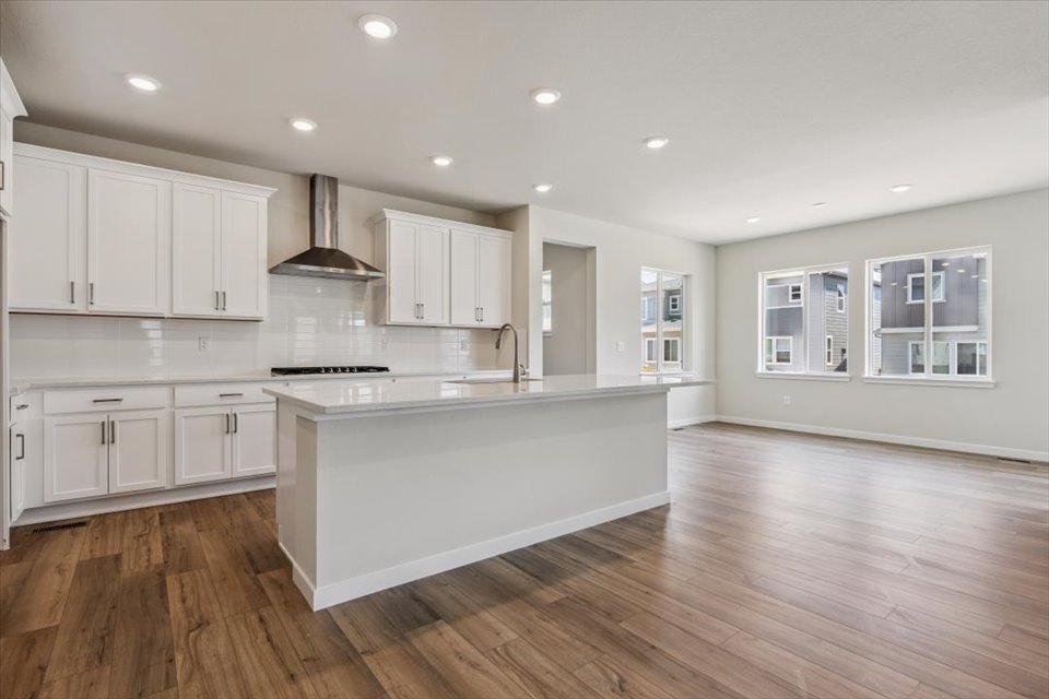 A kitchen with white cabinets.