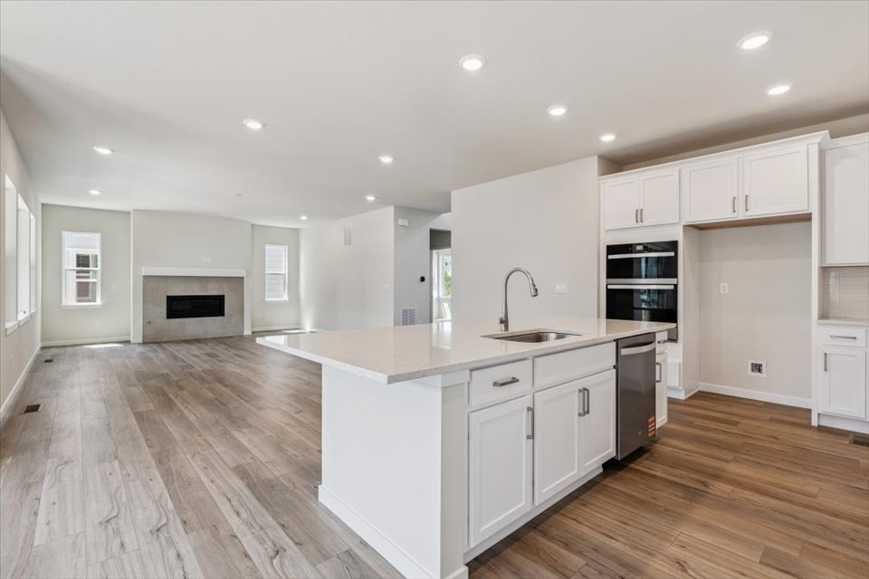 A kitchen with white cabinets.