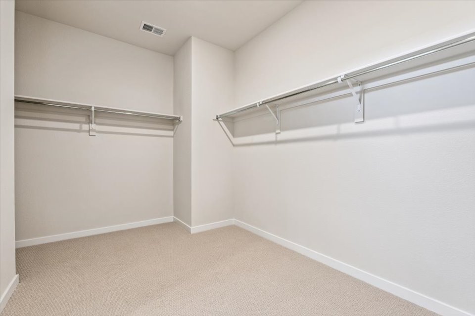 A white room with a metal railing.