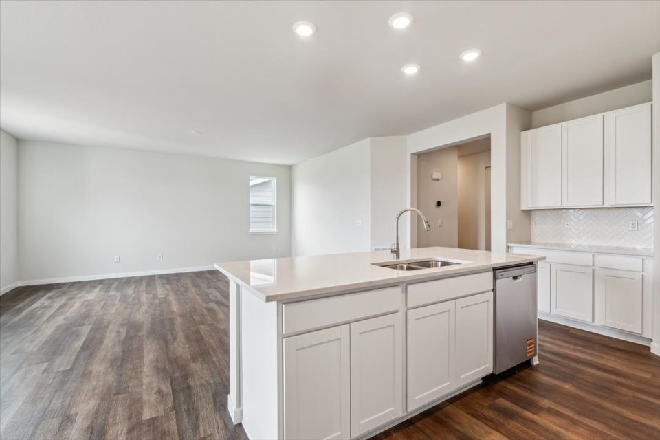 A kitchen with white cabinets.