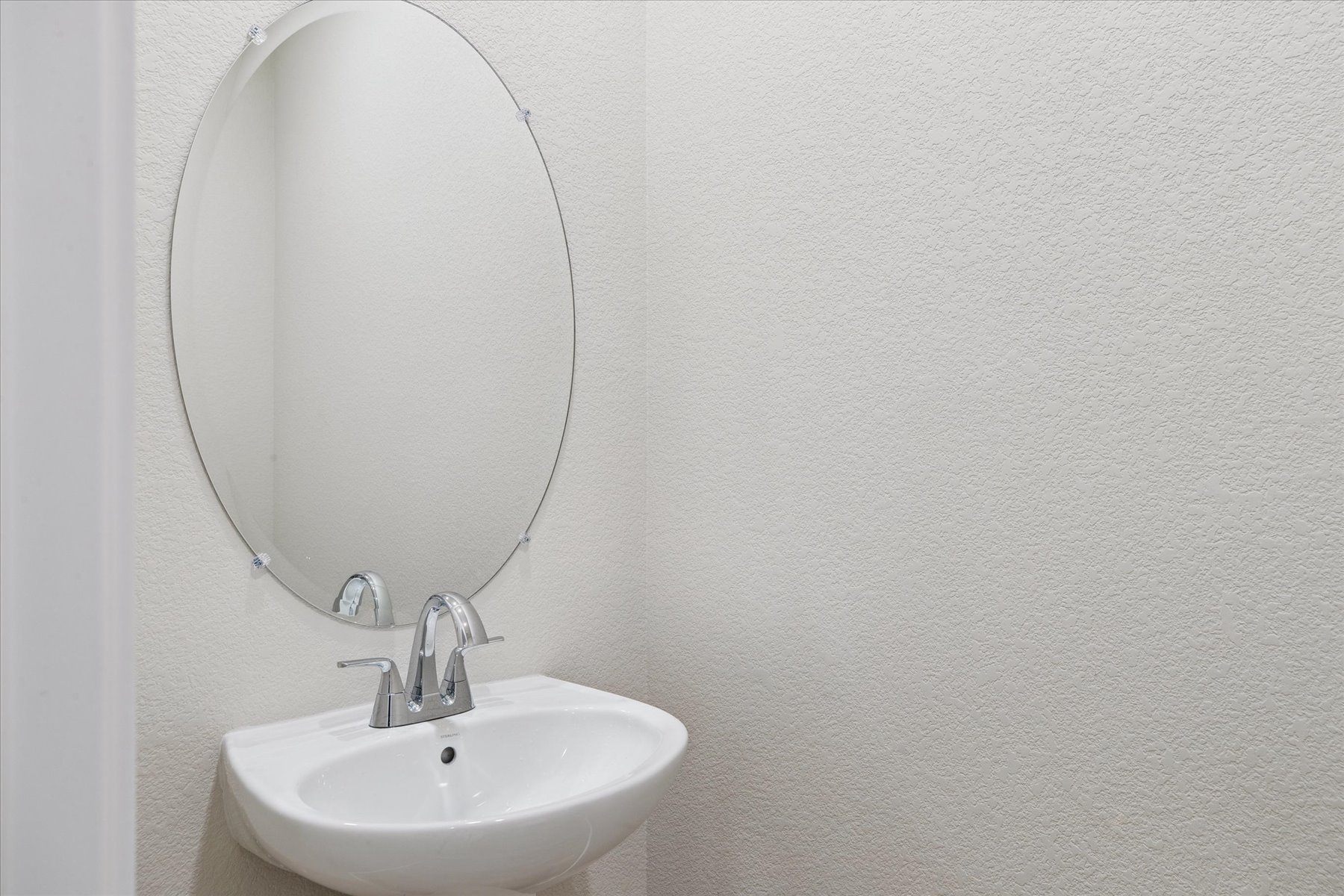 A mirror above a sink.