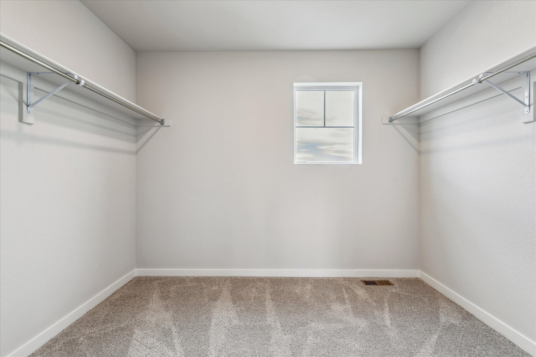 A room with a staircase and a railing.