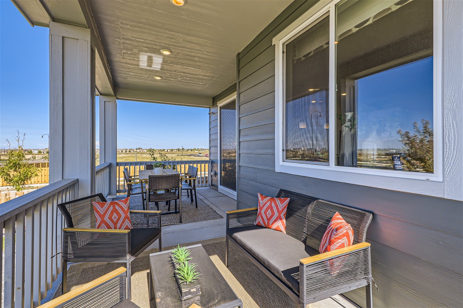 A deck with a couch and chairs.