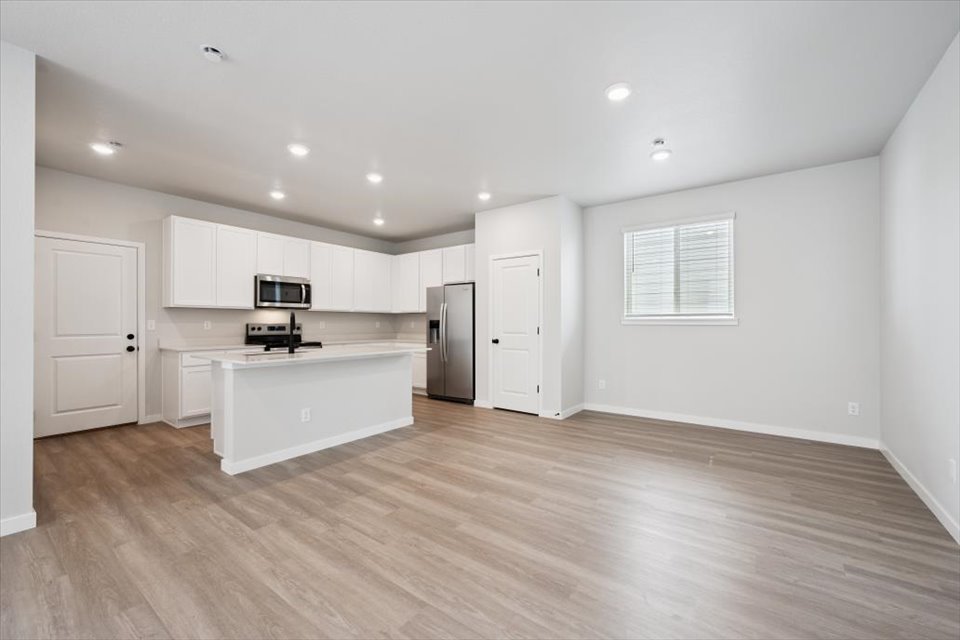 A kitchen with white cabinets.