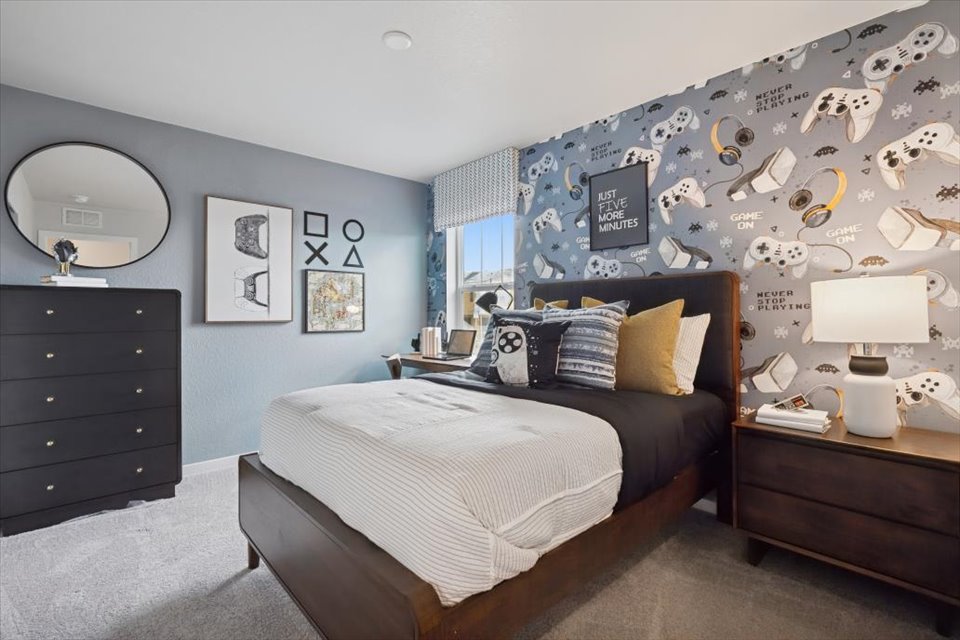 A bedroom with a bed and dresser.