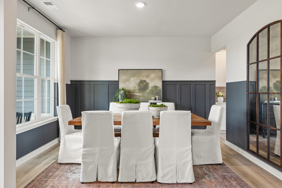 A dining room with a large table.