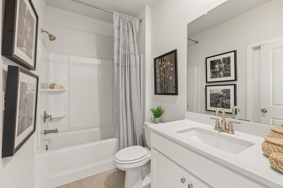 A bathroom with a tub sink and a toilet.