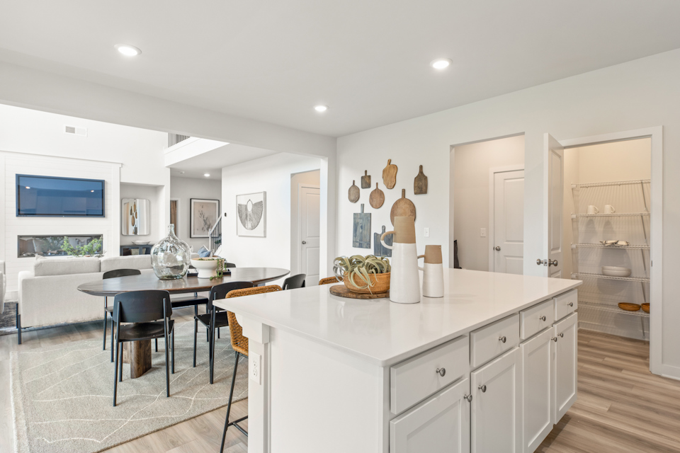 A kitchen with white cabinets.