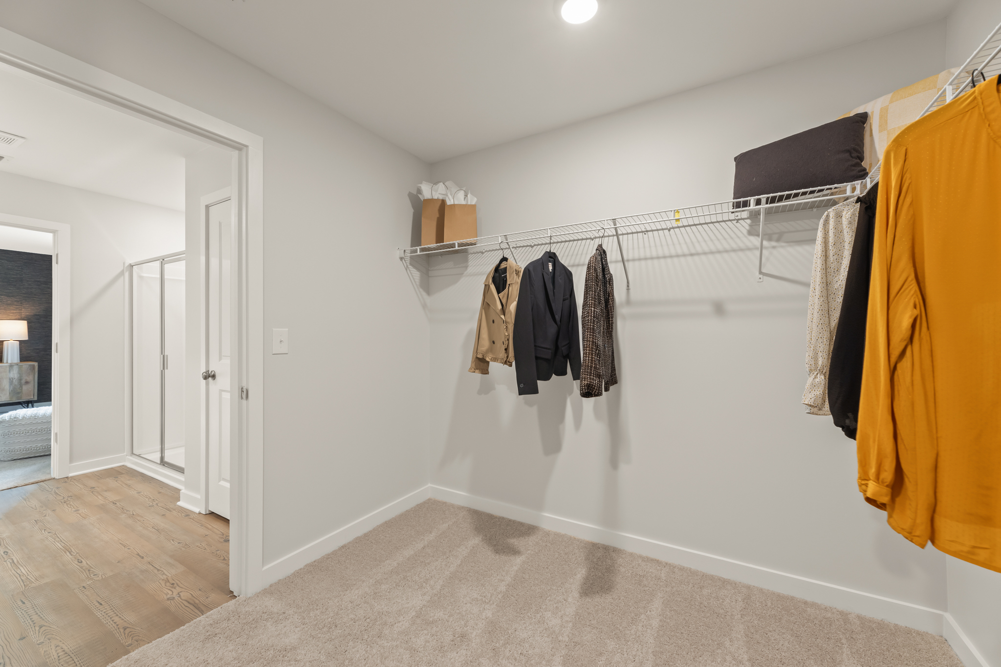 A room with a white wall and a white door with a white wall with a white door and.