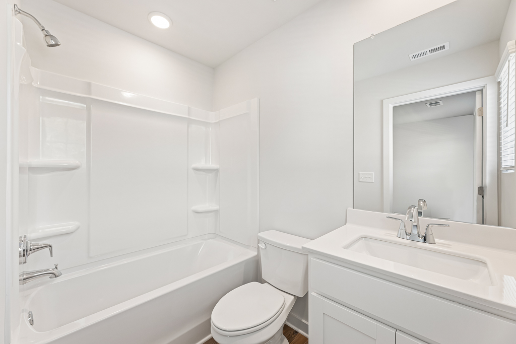 A bathroom with a tub toilet and sink.
