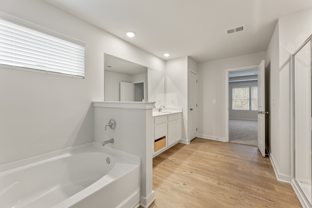 A bathroom with a tub and sink.