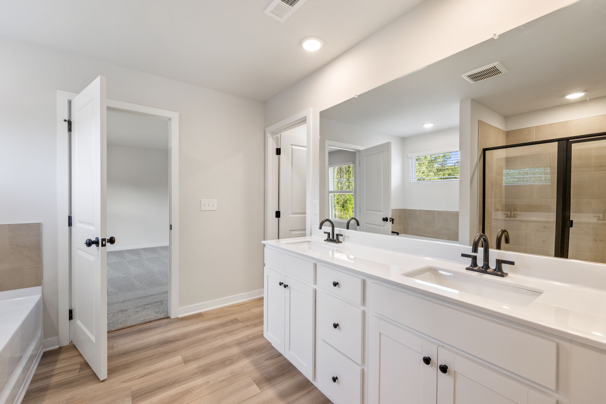 A bathroom with white cabinets.