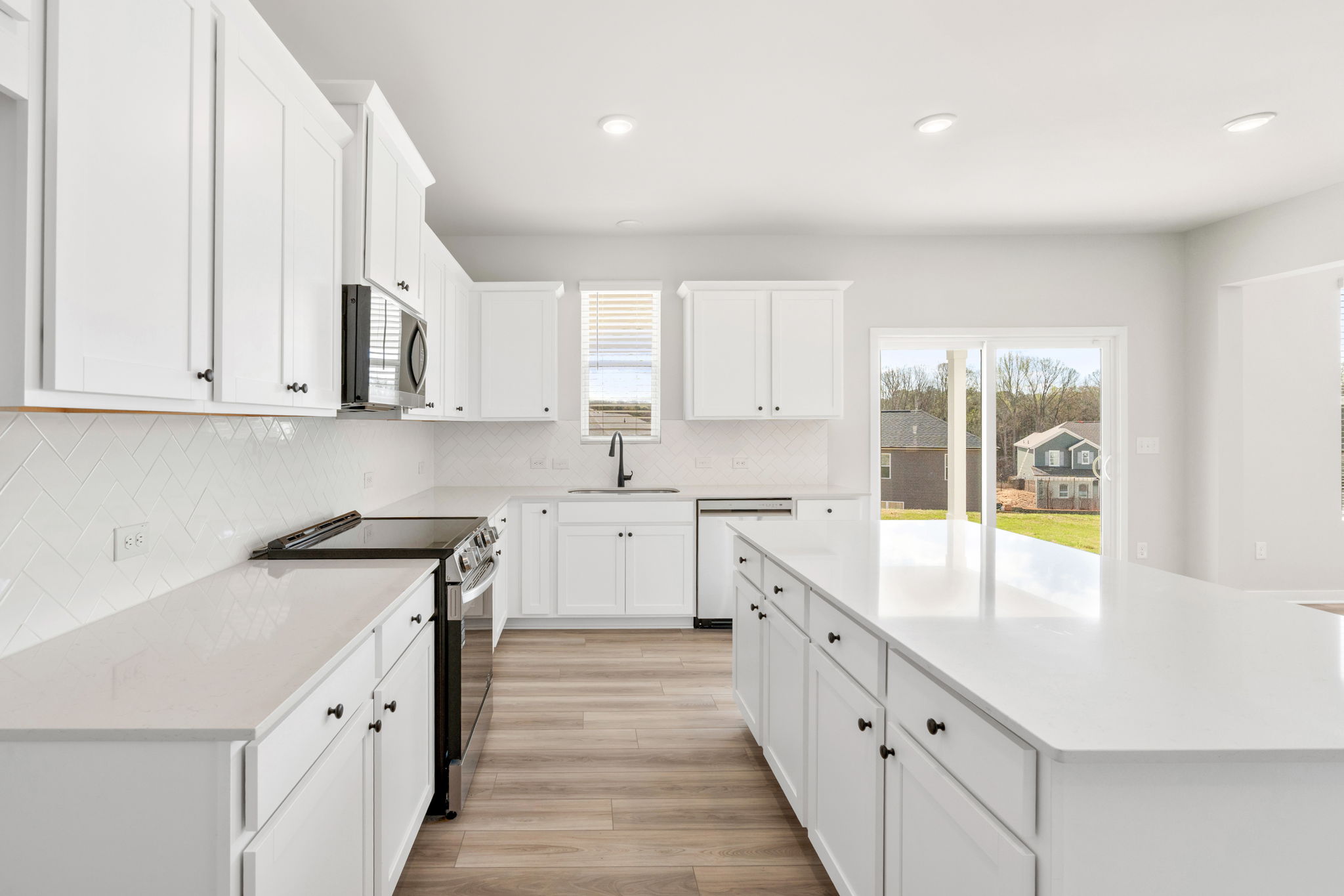 A kitchen with white cabinets.
