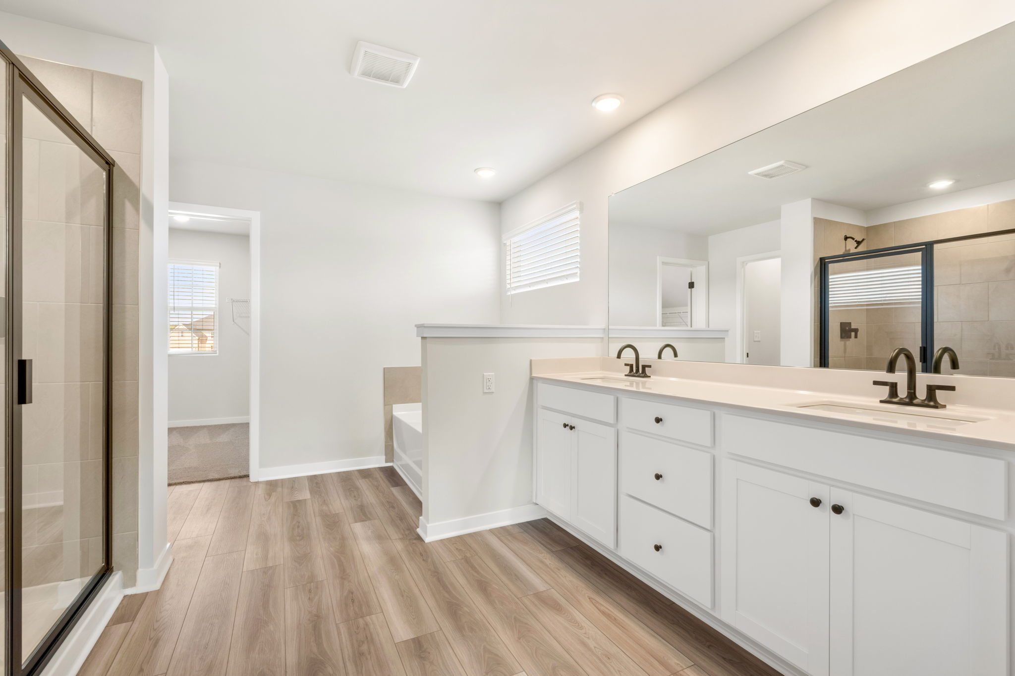 A bathroom with white cabinets.