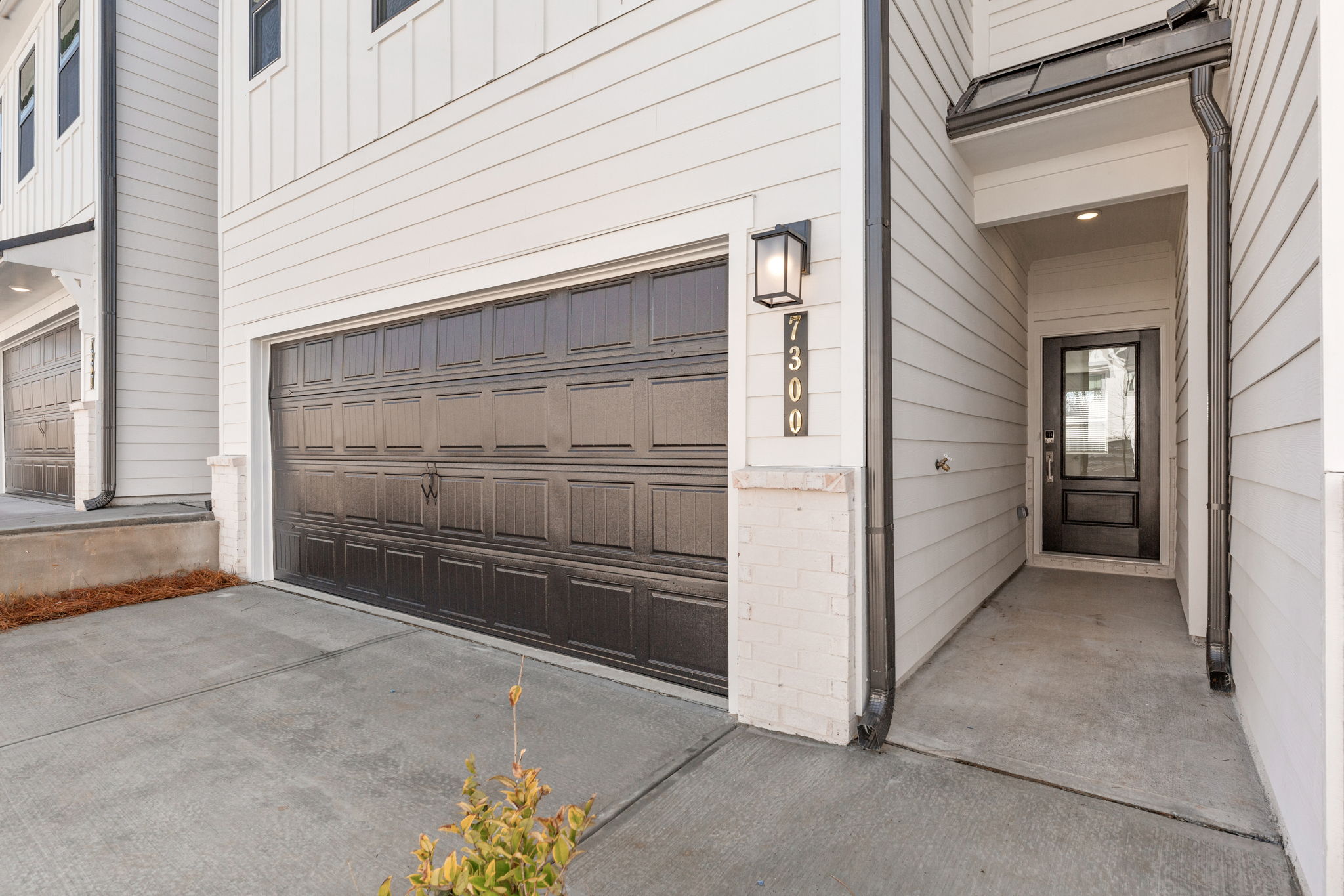 A garage door with a light on the side.