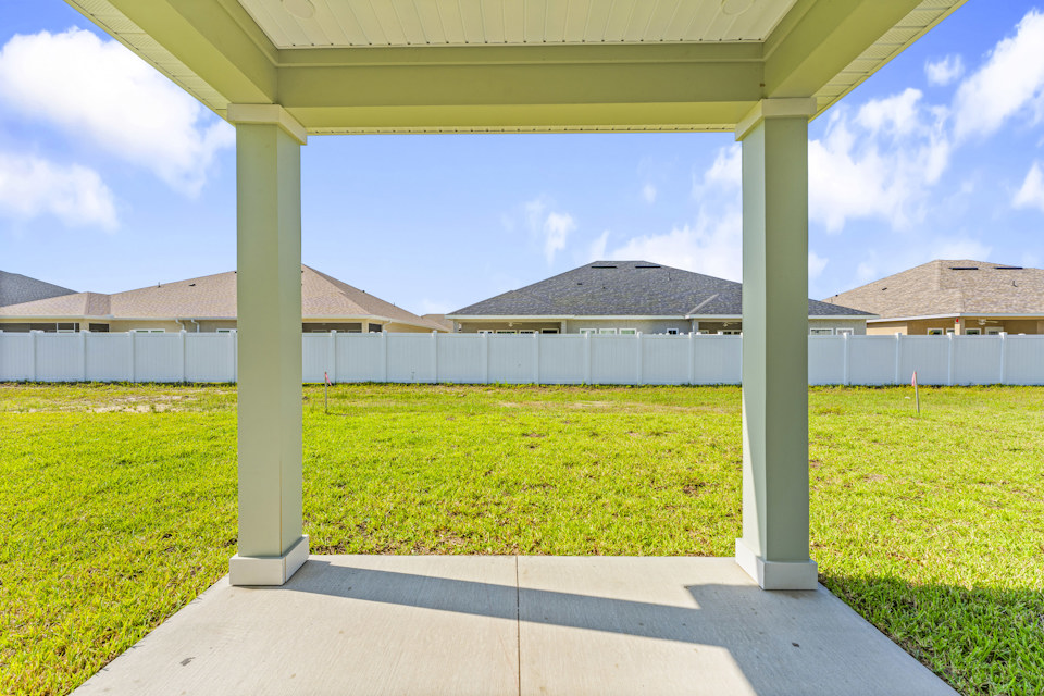 Lot 19 Cedar II Covered Patio with View of Backyard and Privacy Wall at Camden Woods in Kingsland, GA