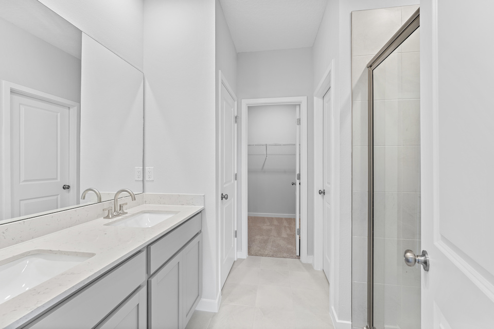 Lot 19 Cedar II Primary Bathroom with Dual Vanity Sink and Glass Shower at Camden Woods in Kingsland, GA