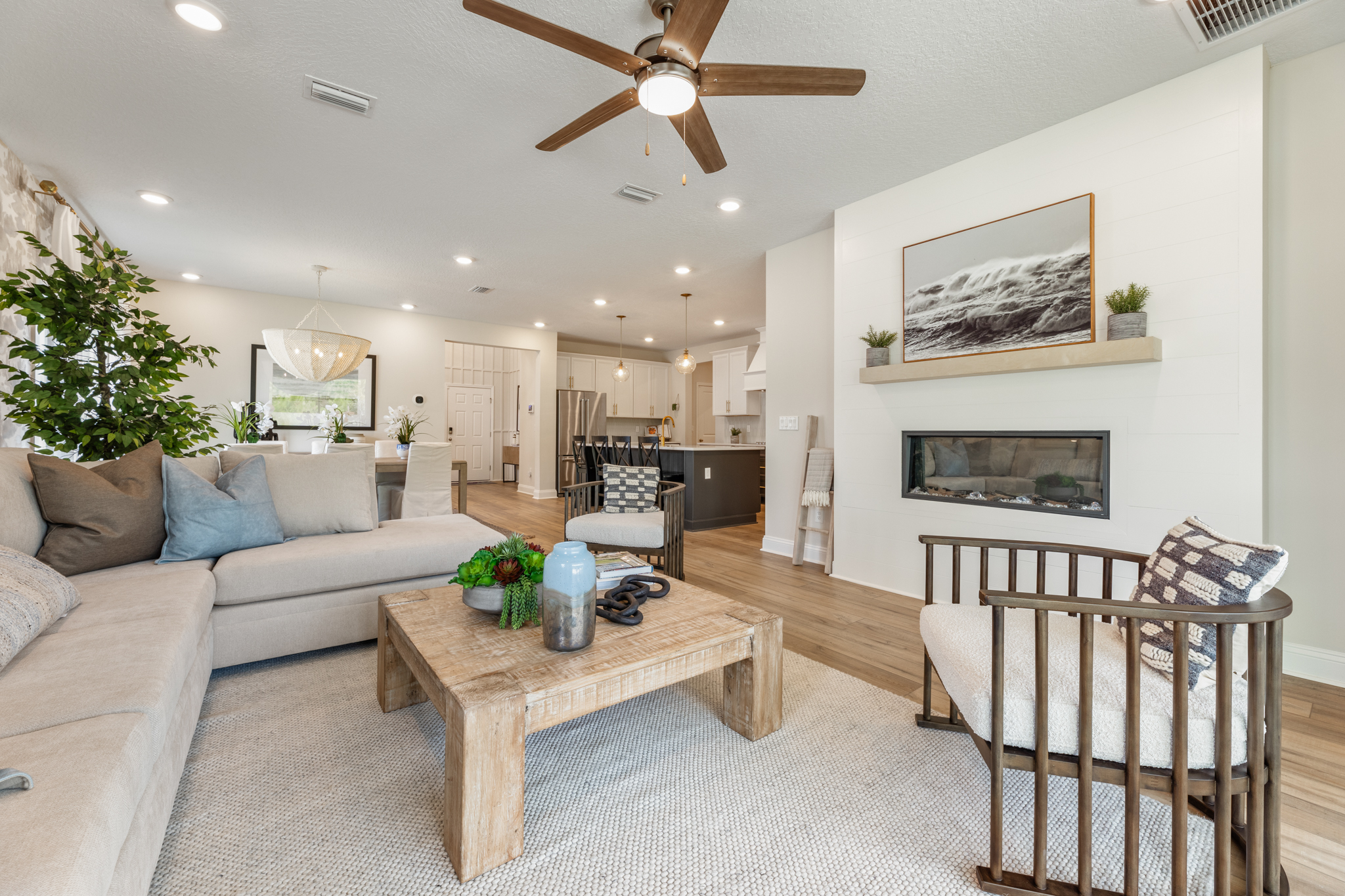 A living room with a table and chairs.