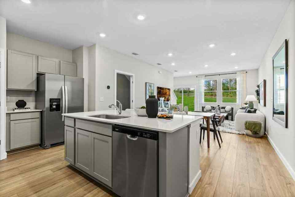 A kitchen with a wood floor.