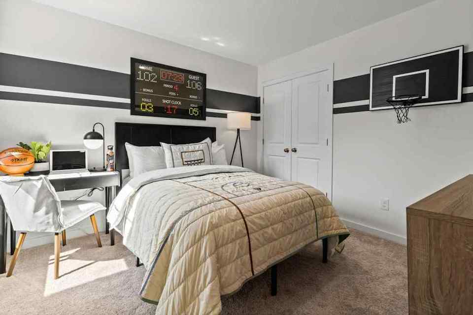 A bedroom with a bed and a table.