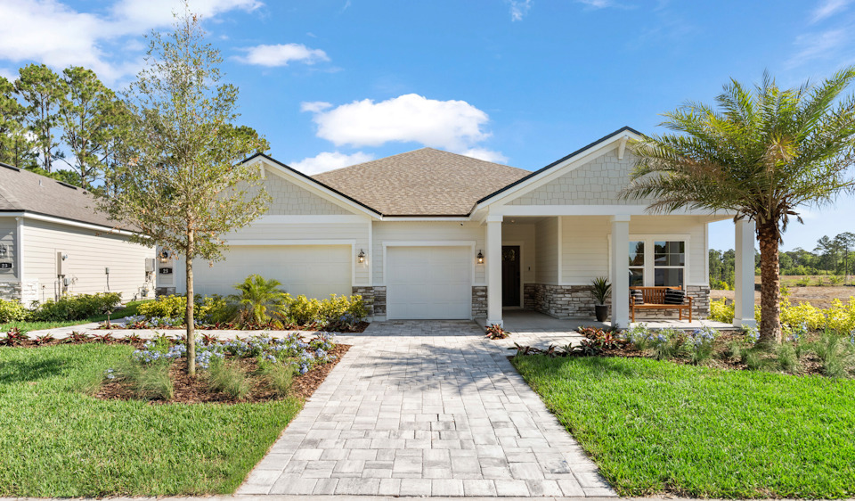 Kenai Model Home Exterior with 3 Bay Garage and Coastal Landscaping at Reserve East in Flagler Beach
