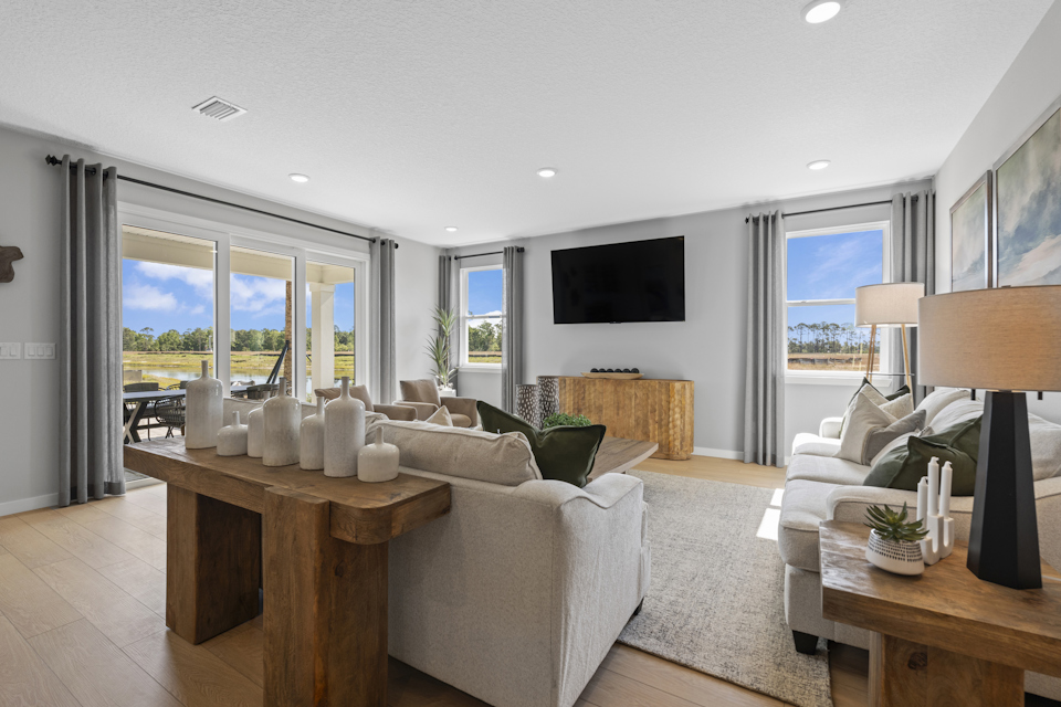 Kenai Model Home Living Room with Large Patio Doors at Reserve East in Flagler Beach