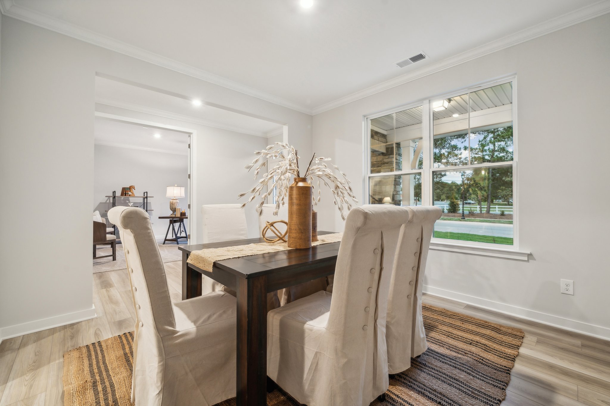A dining room with a table and chairs.