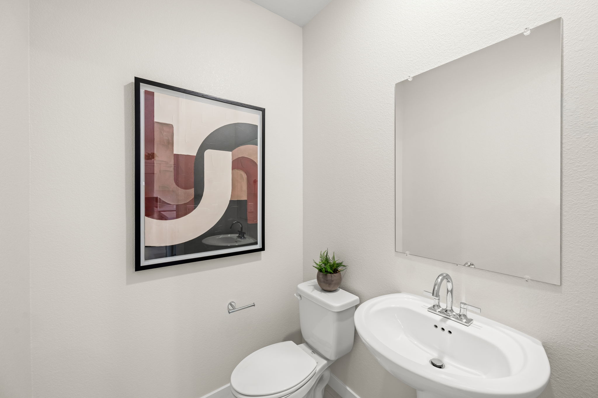 A bathroom with a picture frame.