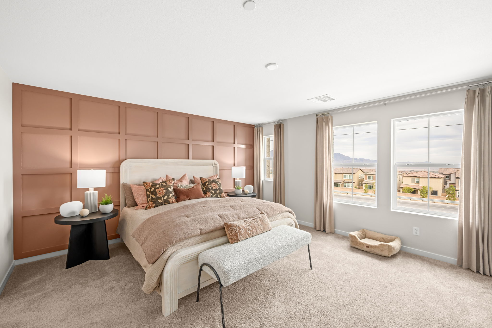 A bedroom with a bed and a table.