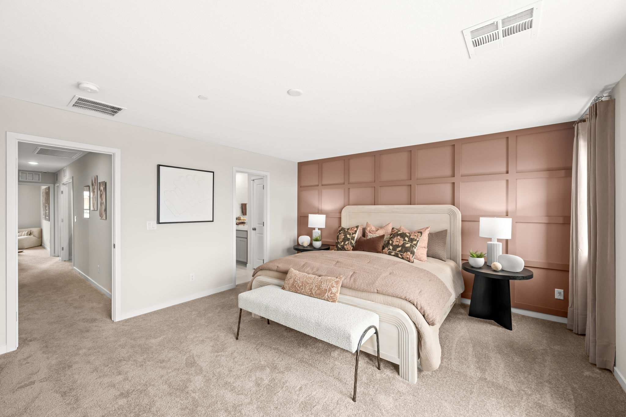 A bedroom with a bed and lamps.