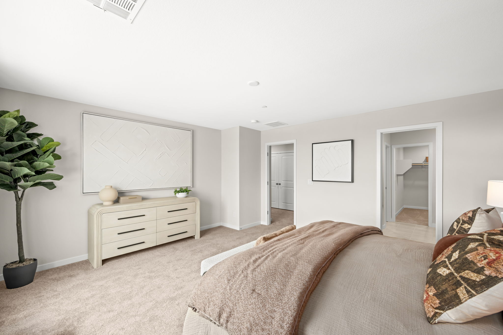 A bedroom with a bed and a dresser.