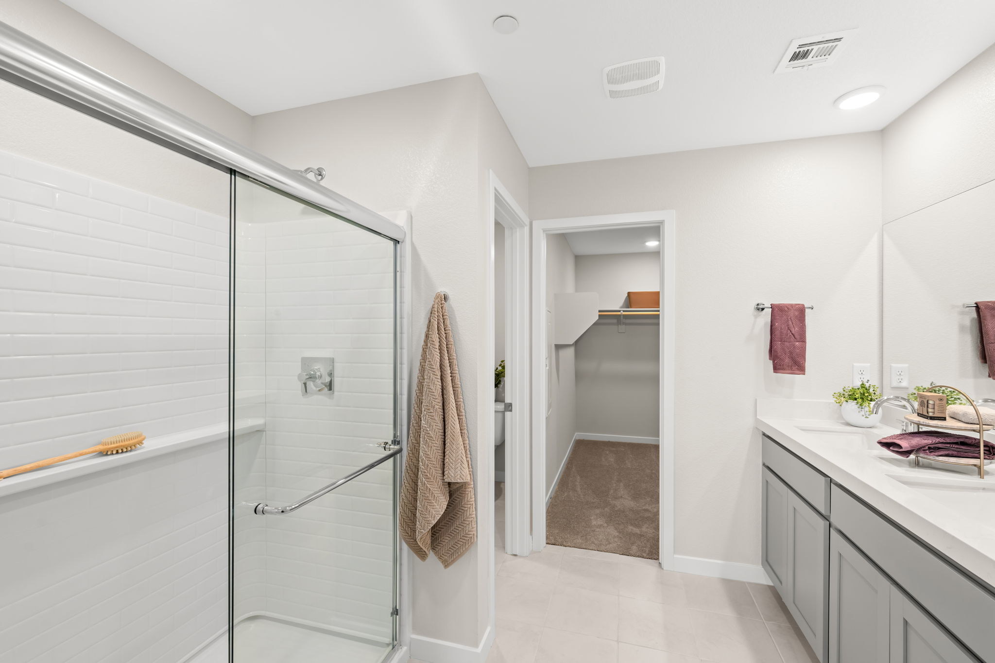 A bathroom with a shower unit and a sink.