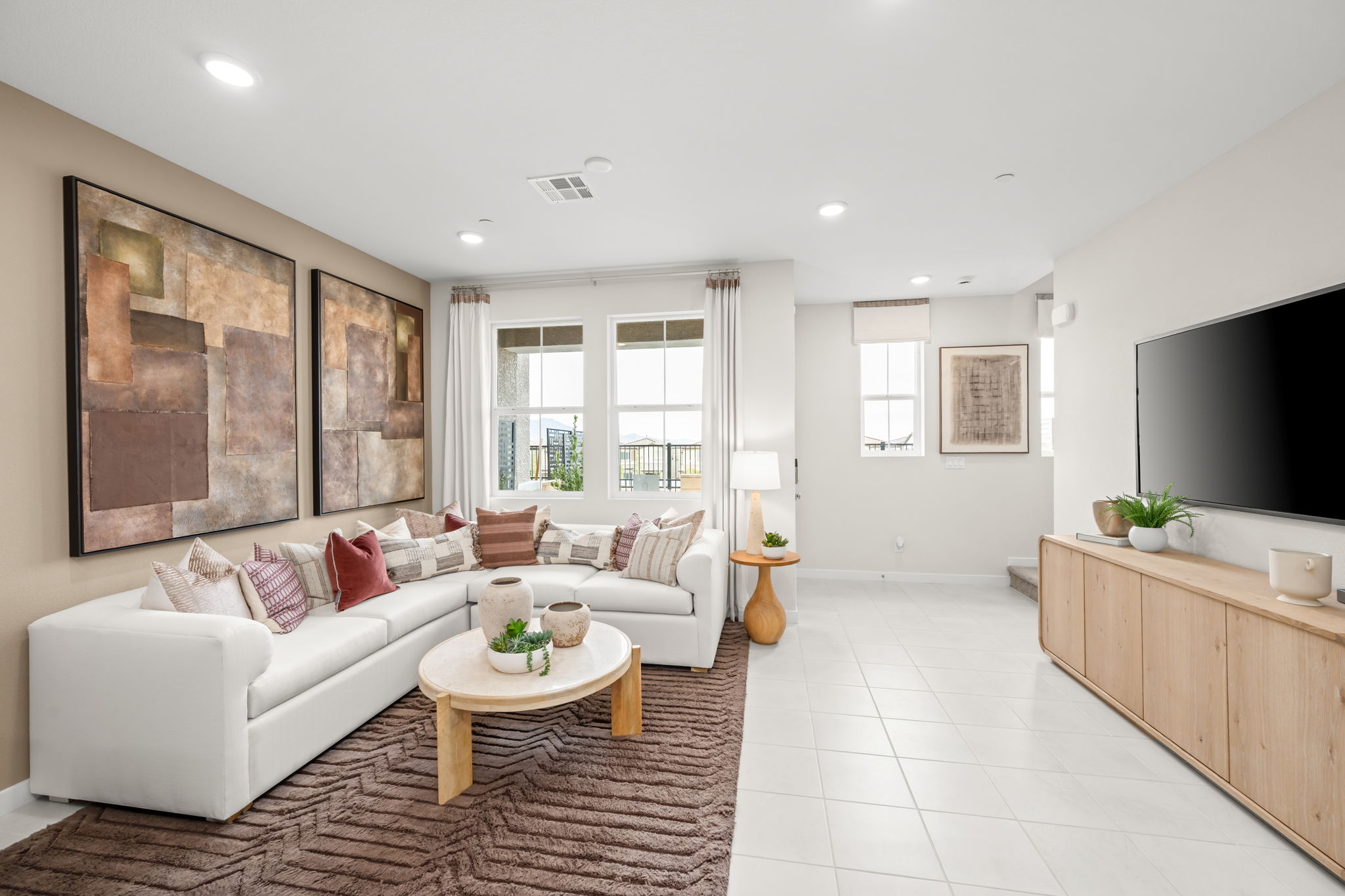 A living room with a white couch and a coffee table.