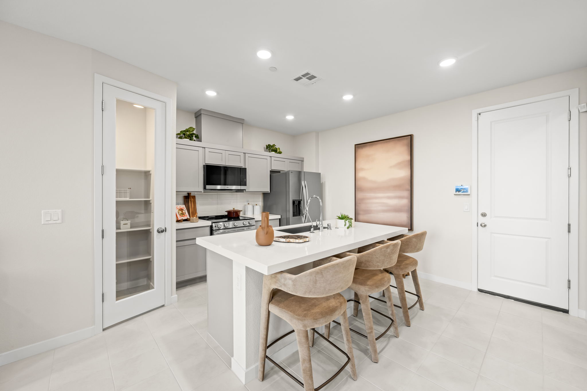 A kitchen with a table and chairs.