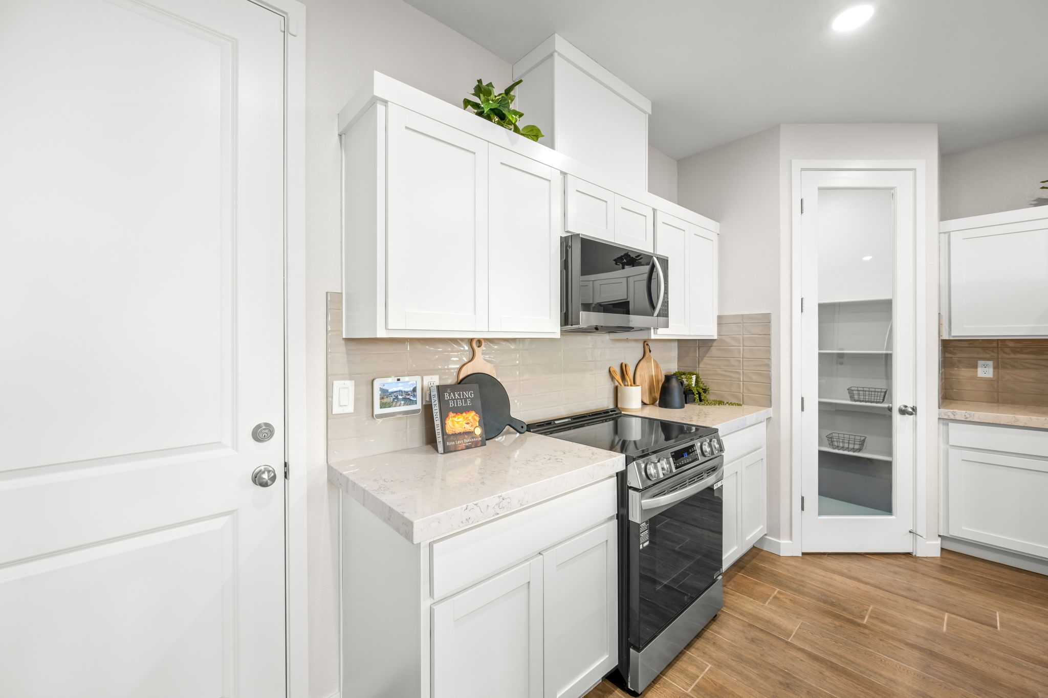 A kitchen with white cabinets.
