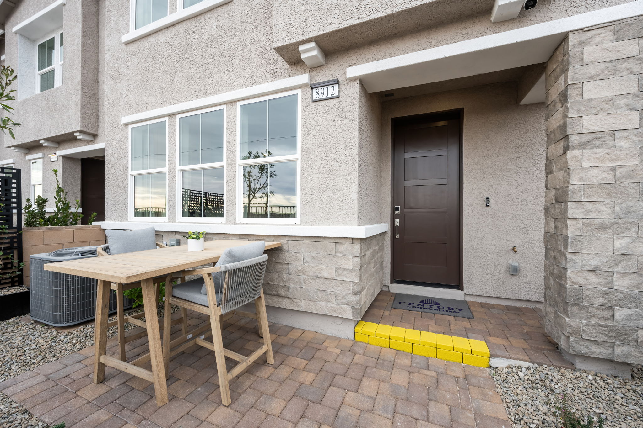 A table and chairs outside a building.