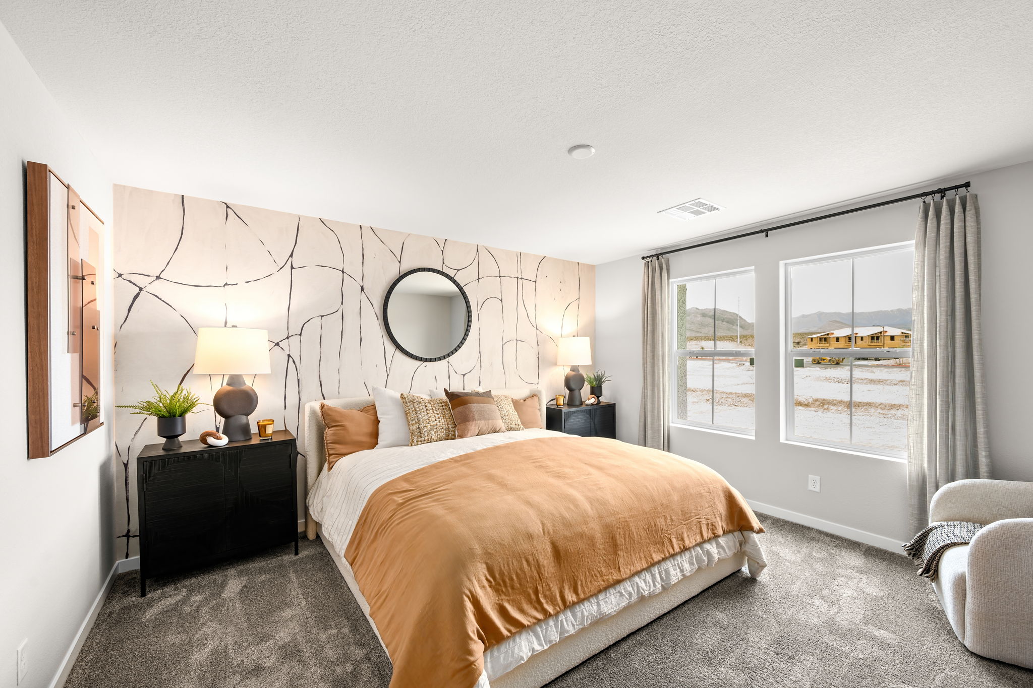 A bedroom with a large mirror.