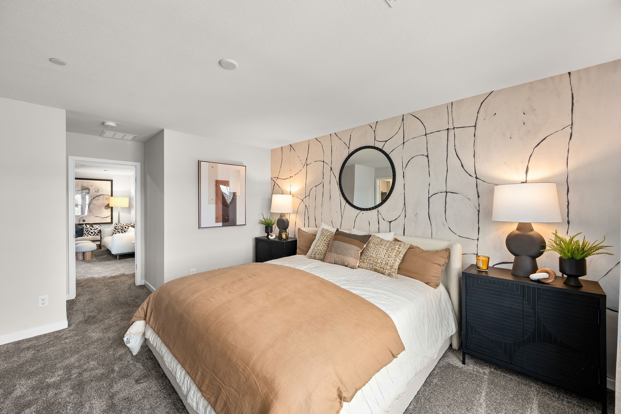 A bedroom with a large mirror.