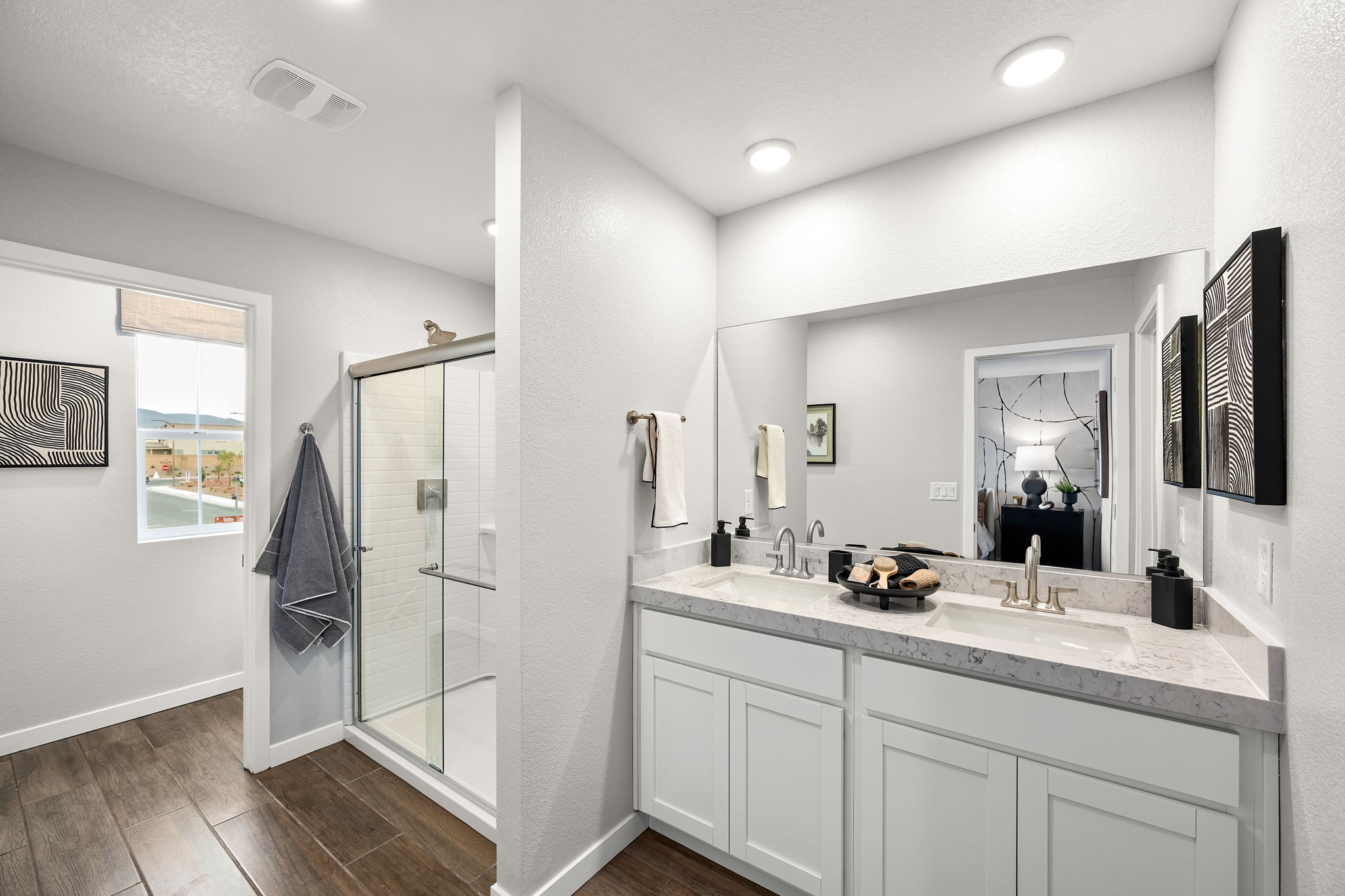 A bathroom with white cabinets.