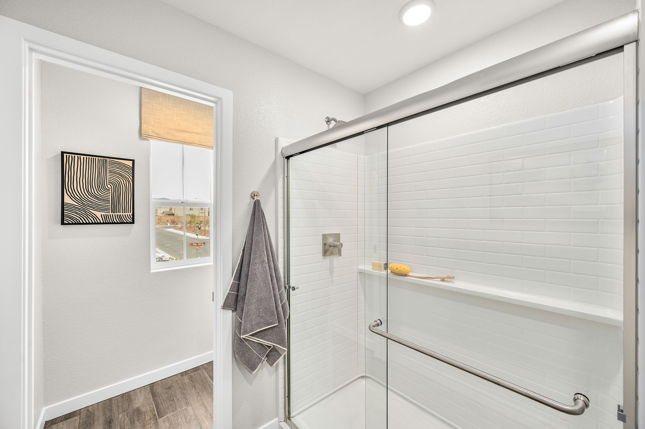 A bathroom with a shower unit and a bathtub.