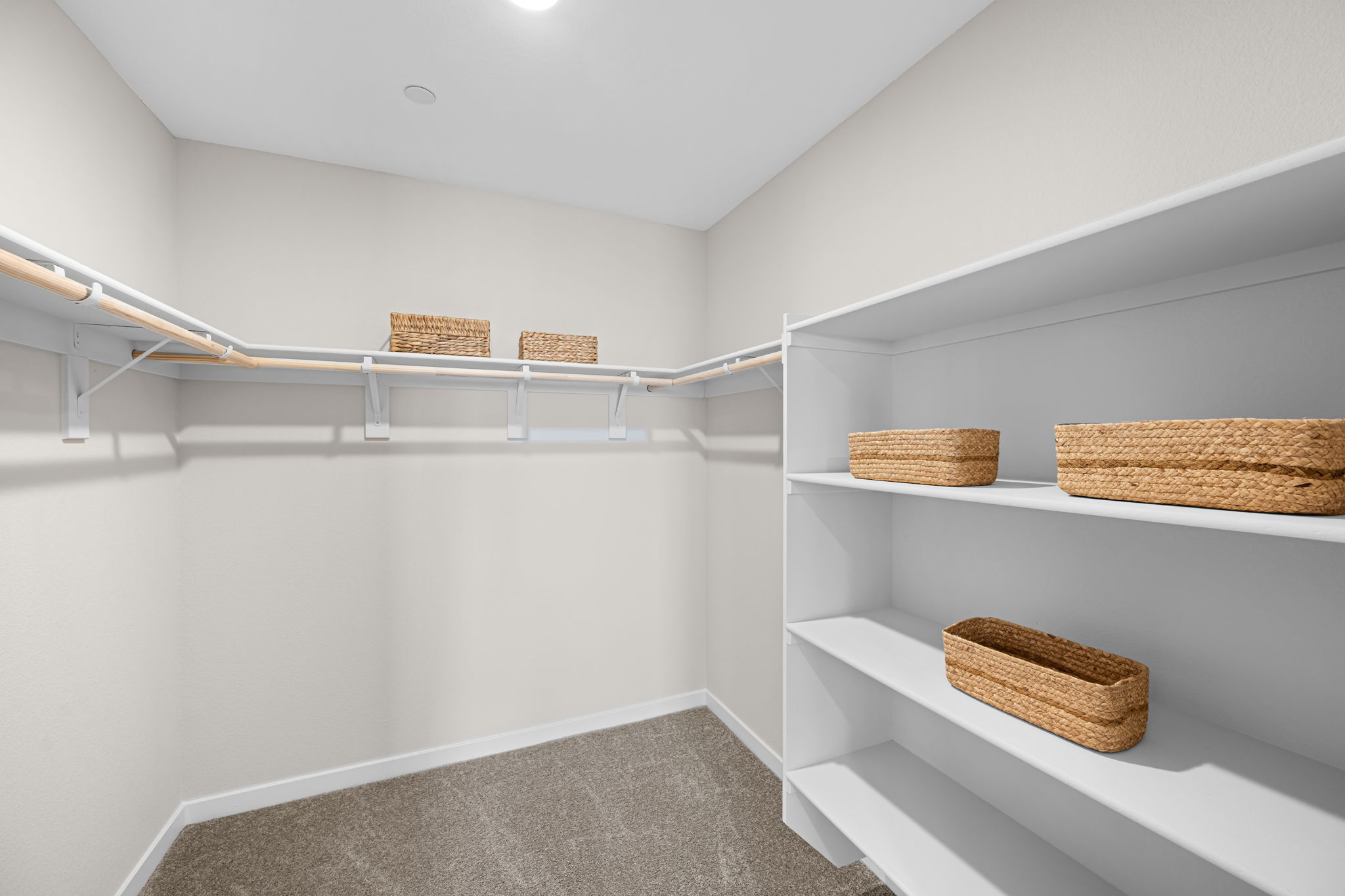 A white room with shelves and baskets.