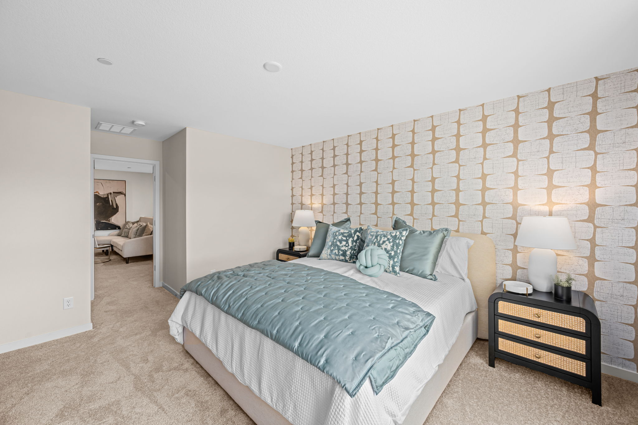 A bedroom with a bed and lamps.